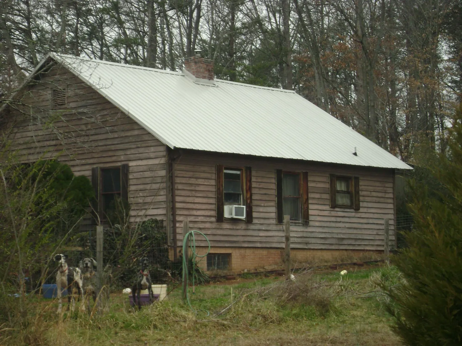 White metal roof on an old wood sided farmhouse, from a Metal Roof Installation job in Sacramento